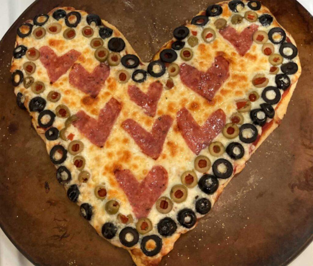 heart-shaped pizza with olives