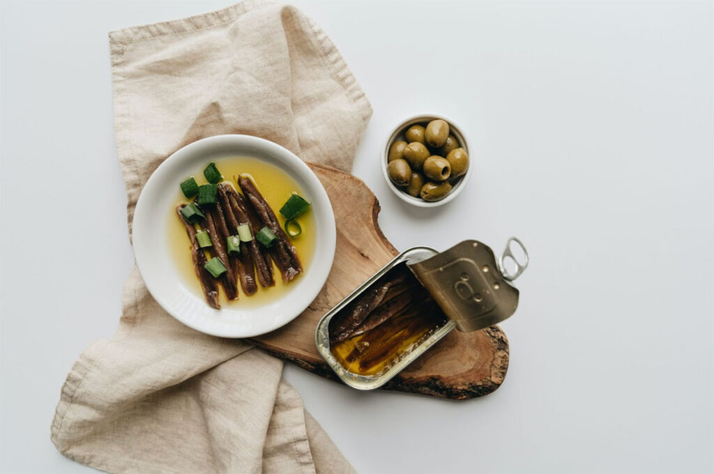 bowl of anchovies with a bowl of olives