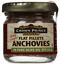 jar of anchovies on homemade pizza