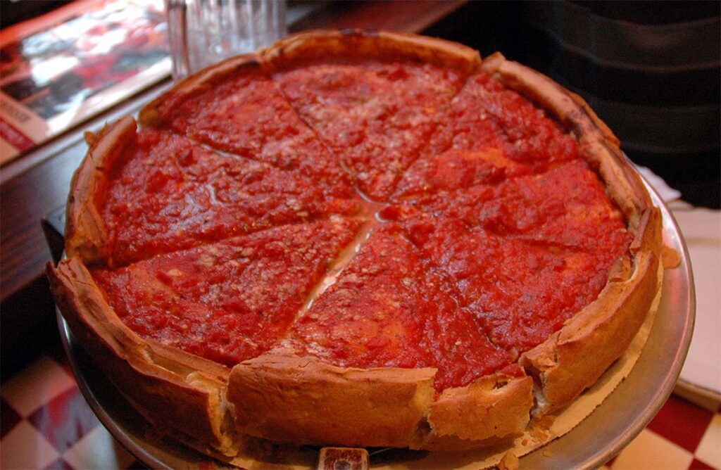chicago style deep dish pizza with knife and fork