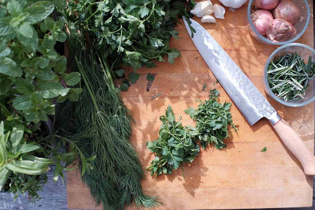 cutting fresh organic herbs for pizza