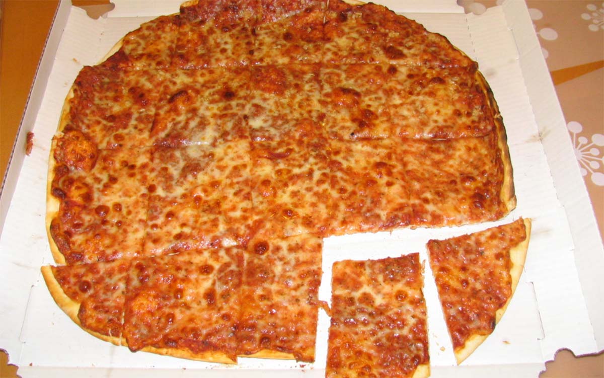 chicago tavern style pizza with cheese in a white pizza box