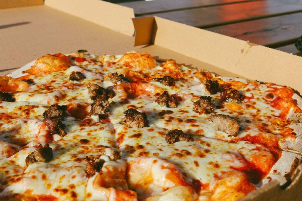 cheesy pizza in a box