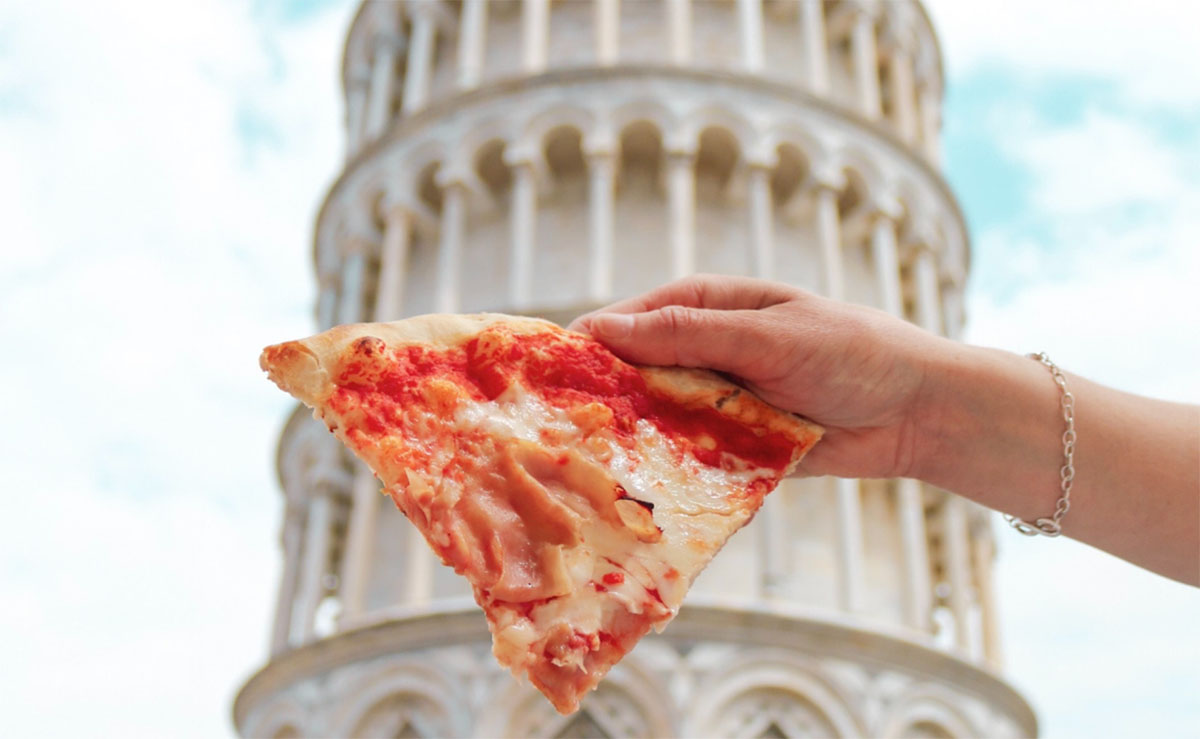 classic italian pizzas with a slice in front of the leaning tower of pisa